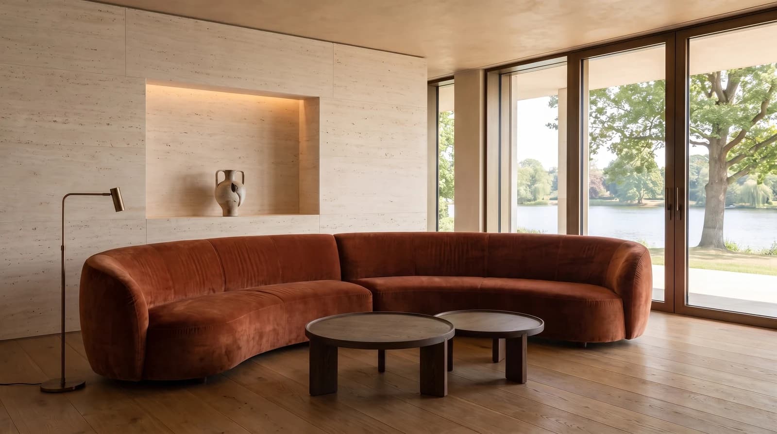 The generated lounge revision with a burnt-sienna velvet sofa, dark oak tables and a travertine wall.