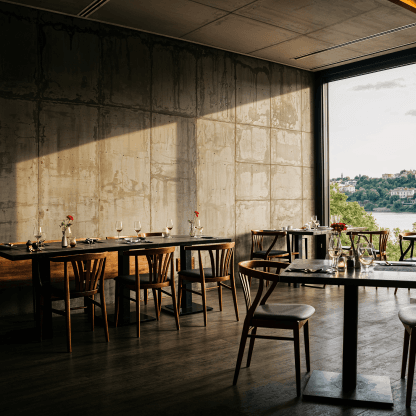 Industrial dining space with concrete walls and wooden furniture